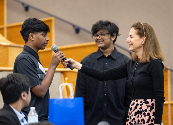 Connecticut Lt. Governor Susan Bysiewicz holds a microphone for a student