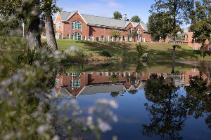 Center for Communications and Engineering building reflected in a pond